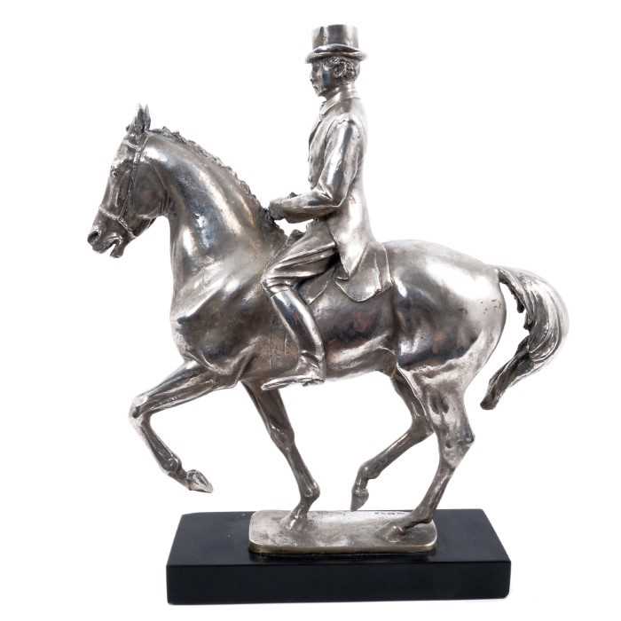 Lot 906 - Bernard Winskill (d. 1980) fine sterling silver model of a horse and rider, in the manner of a dressage competition, hallmarked and raised on black marble plinth, approximately 32cm long