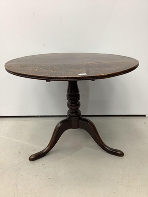 Lot 166 - Antique oak tilt top wine table on turned column and three splayed legs, 82cm diameter