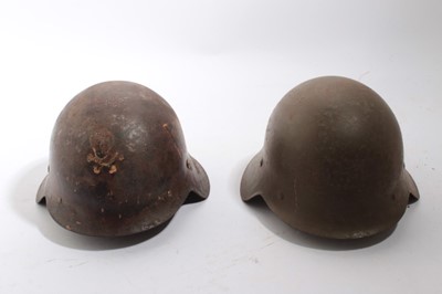 Lot 924 - Spanish M26 steel helmet as worn by Nationalist / Fascist forces during the Spanish Civil War, with painted Facist symbols to exterior, together with another Spanish M26 steel helmet (2)