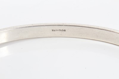 Lot 149 - Tiffany & Co. silver bangle with hook and eye fitting and 18ct gold mounts. London, 1959