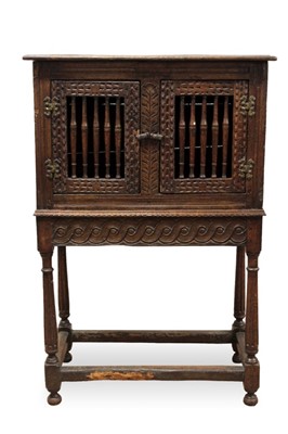 Lot 1444 - Antique oak food hutch enclosed by a pair of bared doors, on carved frieze and fluted turned supports united by stretchers, early elements probably with alterations, 80cm wide x 40cm deep x 121cm h...
