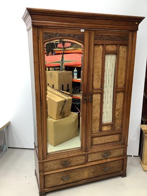 Lot 173 - Late Victorian walnut double wardrobe enclosed by one bevelled mirror door and one glazed and panelled door, with two short and one long drawer below, 132cm wide x 54cm deep x 209cm high