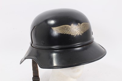Lot 757 - Second World War Nazi Luftschutz helmet with original paint, transfer badge and liner dated 1942
