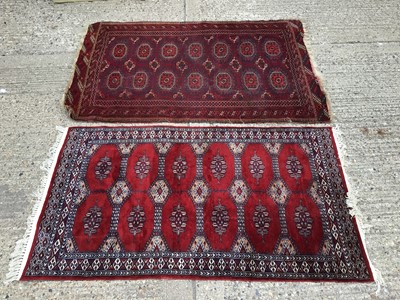Lot 930 - Two Eastern rugs with geometric decoration on red ground 160x104cm, 156x89cm