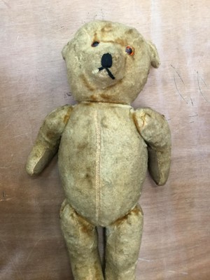 Lot 1910 - Two boxes of toys including teddy, ET figure, Dick Tracy blister packs and other boxed and unboxed figures and games together with a tin plate ariel lift, Action Man and other toys.