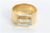 Lot 3271 - Gold (18ct) wide band with an emerald cut...