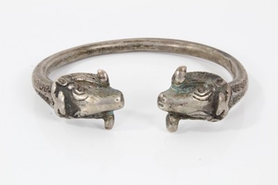 Lot 218 - Persian silver/white metal torque bangle with rams head terminals