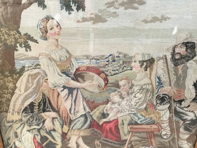 Lot 93 - Antique needlework panel depicting a family group being entertained by a musician, 66cm x 60cm, in mahogany frame with inlaid slip