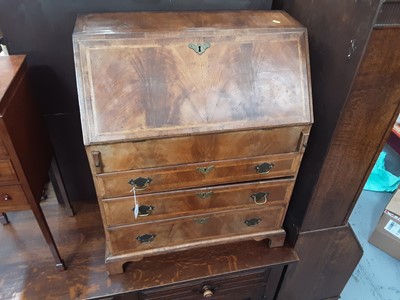 Lot 874 - George I style figured walnut veneered bureau of small proportions, with fitted interior, inlaid herringbone crossbanding and three long graduated drawers below on bracket feet