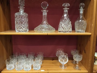 Lot 244 - Set of twelve vintage cut glass whisky tumblers, pair of Victorian cut and etched glass champagne coupes, pair of cut glass brandy balloons, cut glass ships decanter and three other cut glass decan...
