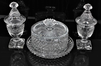Lot 44 - Georgian cut glass butter tub and lid on stand, together with a pair of cut glass urns and covers