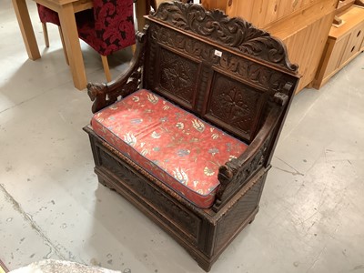 Lot 885 - Antique carved oak monks bench with lion head mounts