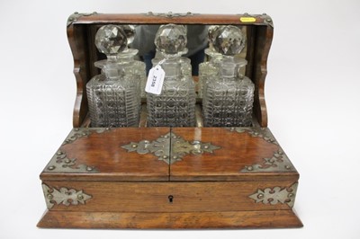Lot 2358 - Edwardian oak tantalus with three cut glass cube decanters