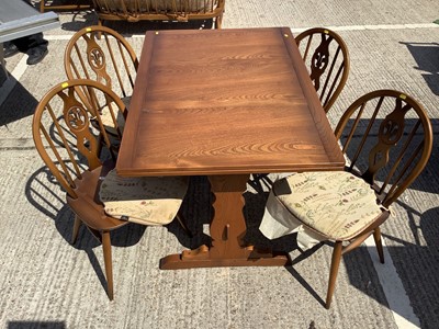 Lot 956 - Ercol draw leaf dining table and set of four chairs