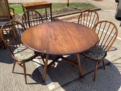Lot 957 - Ercol drop leaf dining table and a set of four stick back chairs
