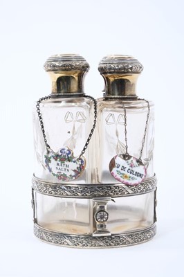 Lot 1964 - Set of four early 20th century French silver and glass toiletry bottles, with gilded decoration, each cap engraved 'Florence'