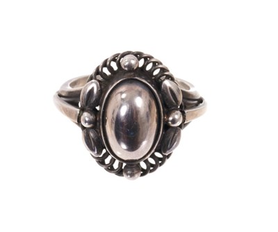 Lot 1978 - Georg Jensen silver ‘moonlight blossom’ dress ring with an cabochon silver centre in silver setting with scrolls and foliage, model 1 A, signed. Finger size approximately M.
