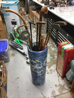 Lot 339 - Blue and white porcelain stick stand filled with a range of sticks, umbrellas and clubs