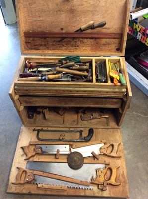 Lot 592 - Large wooden tool chest containing old hand tools, saws etc