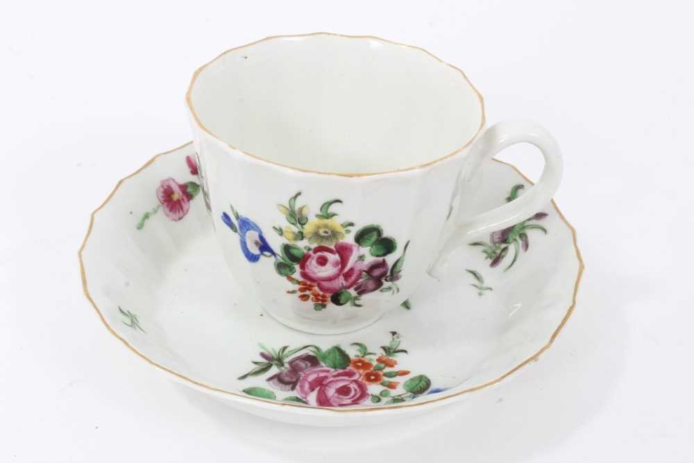 Lot 17 - Worcester faceted coffee cup and saucer, circa 1770, polychrome painted with flowers