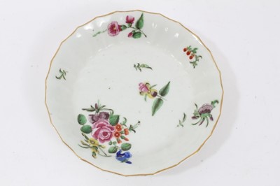 Lot 17 - Worcester faceted coffee cup and saucer, circa 1770, polychrome painted with flowers
