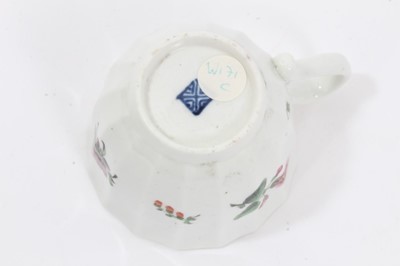 Lot 17 - Worcester faceted coffee cup and saucer, circa 1770, polychrome painted with flowers