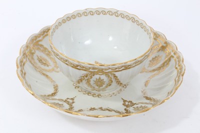 Lot 20 - Worcester fluted tea bowl and saucer, circa 1775-80, decorated in gilt with swags and other patterns, the saucer measuring 14cm diameter