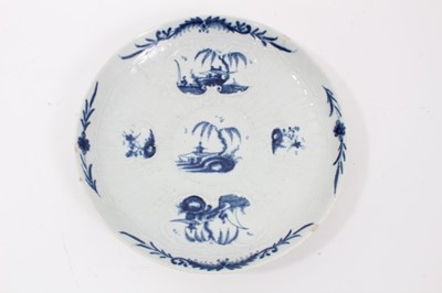 Lot 55 - Worcester blue and white strap-fluted saucer dish, circa 1756, decorated with scrollwork panels containing Chinese landscapes, and foliate patterned rim, 18.5cm diameter