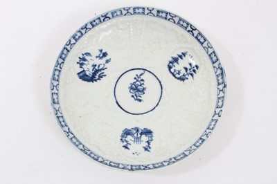 Lot 80 - Lowestoft blue and white saucer, circa 1765, relief moulded, with circular panels containing Chinese landscapes and a patterned border, 12.25cm diameter