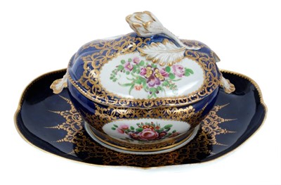Lot 86 - Worcester oval sauce tureen, cover and stand, circa 1772-75, polychrome painted with flowers on a cobalt blue and gilt ground, the stand measuring 23cm across