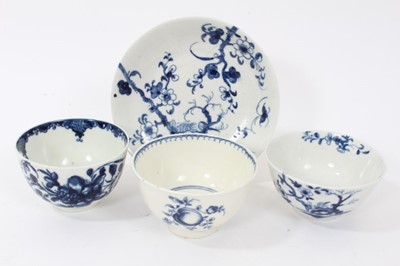 Lot 97 - Worcester tea bowl and saucer, circa 1758, painted in blue with the Prunus Root pattern, together with two other Worcester blue and white tea bowls (4)