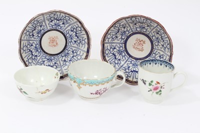 Lot 185 - A Worcester coffee cup, a tea cup, a tea bowl in the Hibiscus pattern, and two Royal Lily pattern large saucers