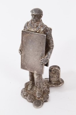 Lot 953 - Modern silver menu holder modelled as a man with a sandwich board, the menu holder formed as a '5 mile' milepost , height 5.5cm, by Thomas Charles Jarvis, London, Thomas Charles Jarvis
