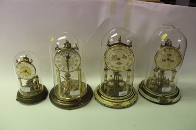 Lot 2445 - Four perpetual motion mantle clocks under domes