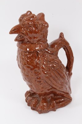 Lot 136 - Unusual treacle glazed pottery jug in the form of a bird, 25cm high