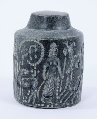 Lot 801 - Rare early carved stone cylinder seal, possibly Assyrian, with pierced terminal and profusely carved with figures, birds and animals, the base similarly carved with winged figures flanking a cross,...