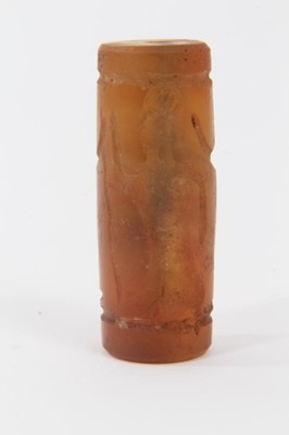 Lot 805 - Ancient carved carnelian cylinder seal, Near Middle East, carved with figures, approximately 3.5cm long