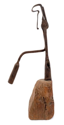 Lot 824 - Large 18th century wrought iron nip rush light holder, raised on tapered square wooden base