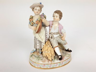 Lot 1932 - Meissen porcelain group, late 19th century, the boy sat on a sheaf of wheat, listening to a girl playing the lute, marks to base, 15cm high
