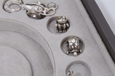 Lot 270 - Collection of silver and white metal charms within a Stackers jewellery box