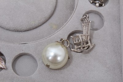 Lot 270 - Collection of silver and white metal charms within a Stackers jewellery box