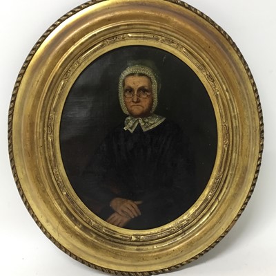 Lot 95 - English School, mid 19th century, oil on canvas, oval, portrait of an austere woman with glasses and white bonnet, 26 x 22cm, gilt frame