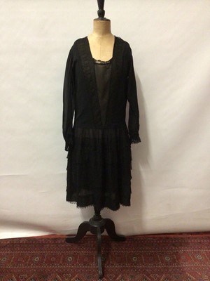 Lot 2054 - Circa 1910 Black silk crepe dress with a tiered lace skirt, long sleeves and lace inserts.