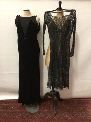 Lot 2055 - 1920 Black velvet evening dress, bias cut and silk crepe panels to bodice.  Plus an all over black lace evening dress with long sleeves and buttoned cuff.
