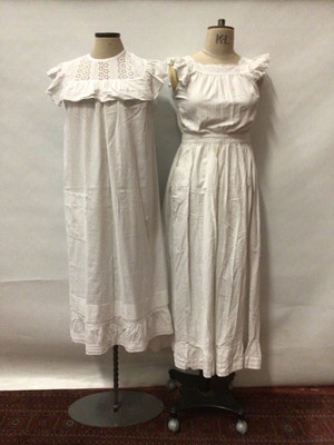 Lot 2066 - Two Edwardian full length pinafores with broderie anglaise insertd and frilly cap sleeves.  Plus three white cotton Edwardian nighties with white-work, lace and broderie anglaise trims.