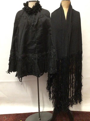 Lot 2067 - Victorian black silk and  lace cape embellished with beading and ruffled ribbon edging. Black silk piano shawl with fringing, white lace capelet and two pairs of ladies gauntlet gloves.