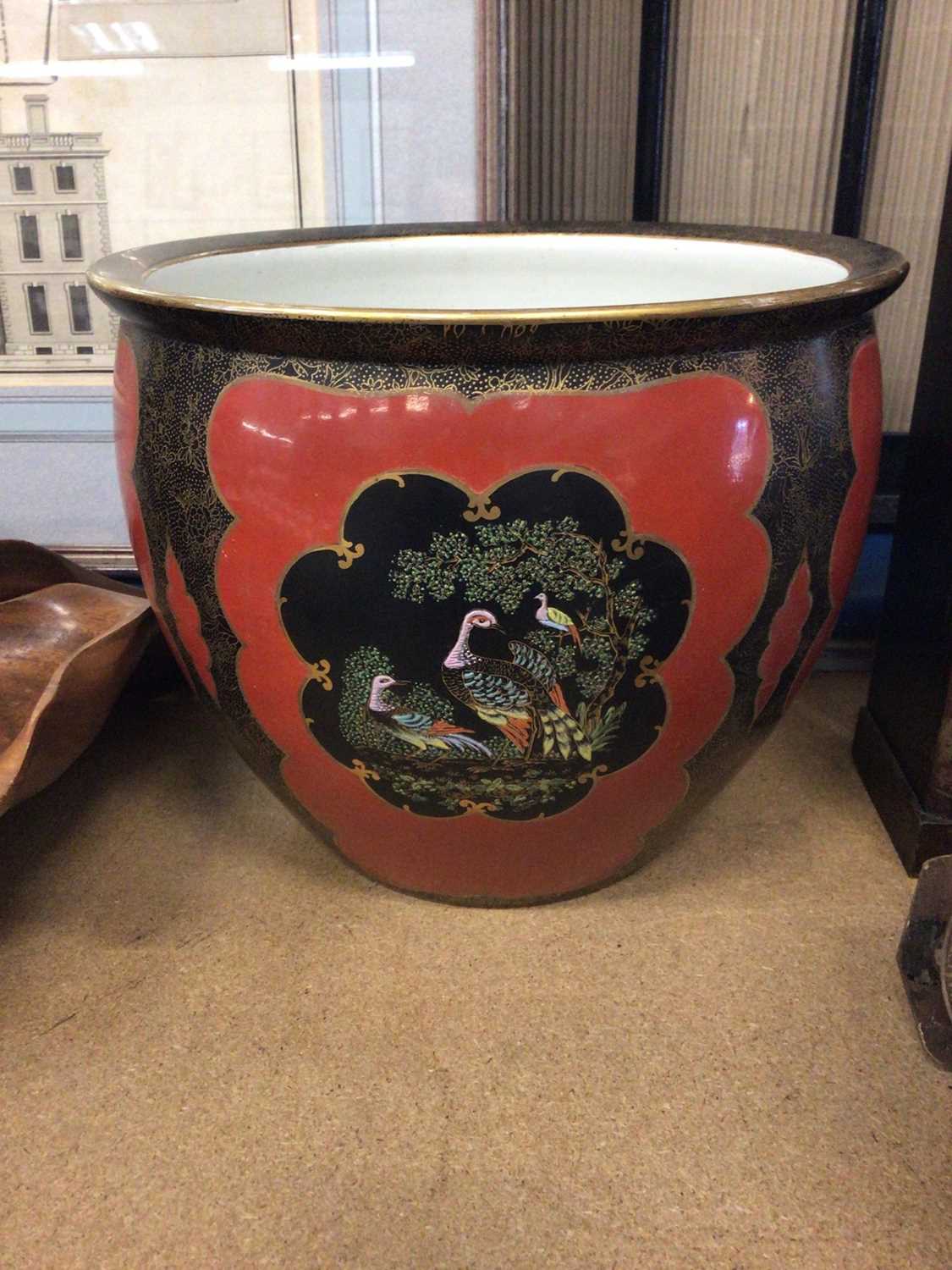 Lot 132 - Carlton Ware jardiniere, decorated with tropical birds on a red and gilt ground