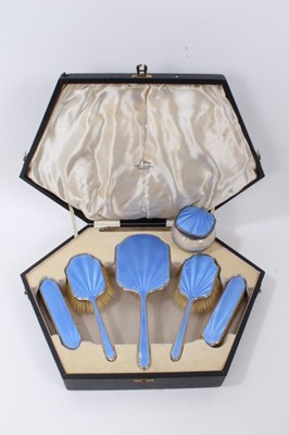 Lot 151 - 1930s Art Deco five piece silver dressing table set, comprising a hand mirror and four brushes with blue guilloche enamel decoration