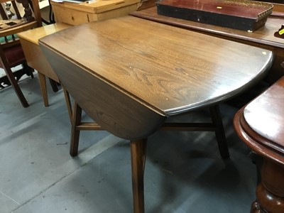 Lot 926 - Ercol elm oval dropleaf table and set four Ercol stick back chairs