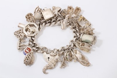 Lot 42 - Silver charm bracelet with large quantity of silver and white metal novelty charms